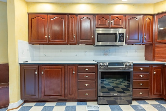 1919 Tait Circle Rd, Kettering, OH 45429 - kitchen featuring appliances with stainless steel finishes, light floors, light countertops, and backsplash