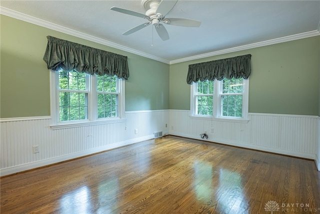 1919 Tait Circle Rd, Kettering, OH 45429 - spare room with a wainscoted wall, ceiling fan, wood finished floors, and crown molding