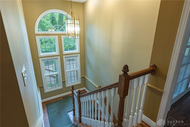 1919 Tait Circle Rd, Kettering, OH 45429 - stairway featuring a chandelier and wood finished floors