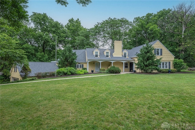 1919 Tait Circle Rd, Kettering, OH 45429 - new england style home featuring a chimney, a front lawn, and a porch