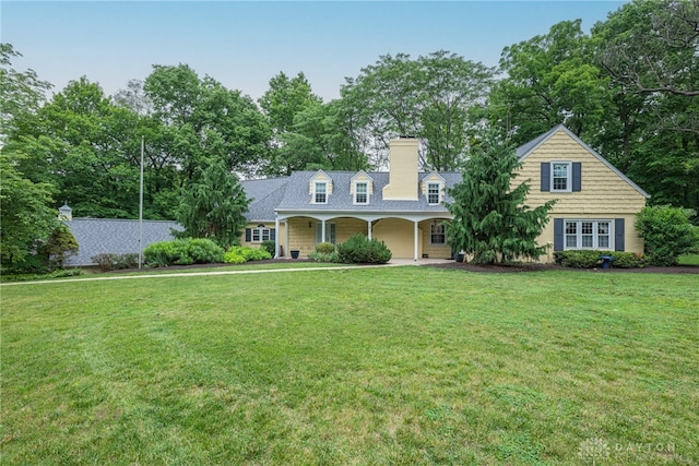 1919 Tait Circle Rd, Kettering, OH 45429 - cape cod house with a front lawn, a chimney, and view of scattered trees