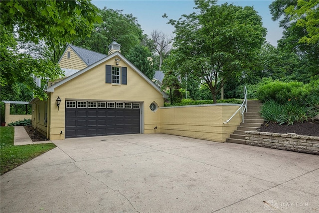 1919 Tait Circle Rd, Kettering, OH 45429 - garage featuring concrete driveway and view of wooded area