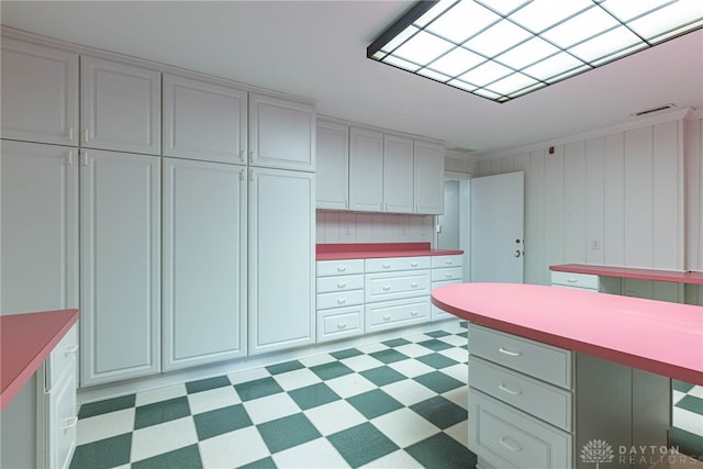 1919 Tait Circle Rd, Kettering, OH 45429 - kitchen with light floors, light countertops, and white cabinets