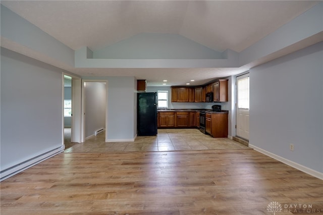 1717 Pershing Ave, Middletown, OH 45044 - kitchen with black appliances, vaulted ceiling, light wood-style flooring, dark countertops, and a baseboard radiator