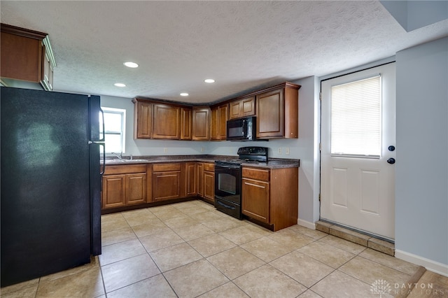 1717 Pershing Ave, Middletown, OH 45044 - kitchen with black appliances, a textured ceiling, dark countertops, recessed lighting, and brown cabinetry