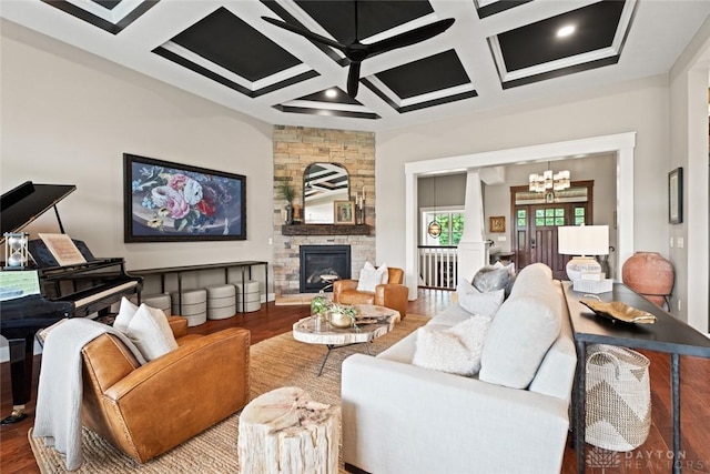 79 White Beech Ct, Springboro, OH 45066 - living room with coffered ceiling, wood finished floors, a stone fireplace, a ceiling fan, and a chandelier