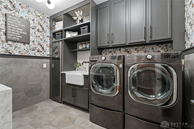 79 White Beech Ct, Springboro, OH 45066 - laundry area with washer and dryer, cabinet space, tile walls, and light tile patterned floors