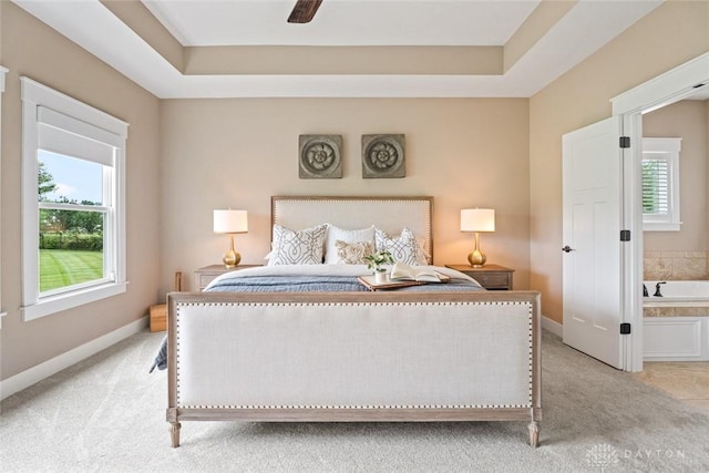 79 White Beech Ct, Springboro, OH 45066 - bedroom featuring light colored carpet, a tray ceiling, and a ceiling fan