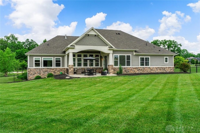 79 White Beech Ct, Springboro, OH 45066 - back of house with stone siding, a patio, and roof with shingles