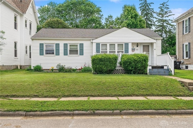 313 N High St, Wilmington, OH 45177 - view of front of property featuring a front lawn and a shingled roof