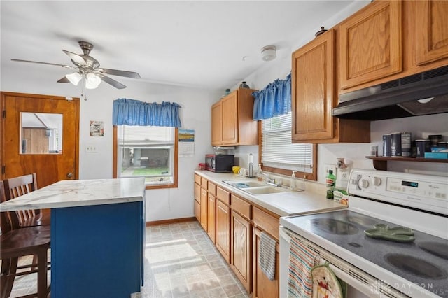 313 N High St, Wilmington, OH 45177 - kitchen with white range with electric cooktop, black microwave, under cabinet range hood, and light countertops