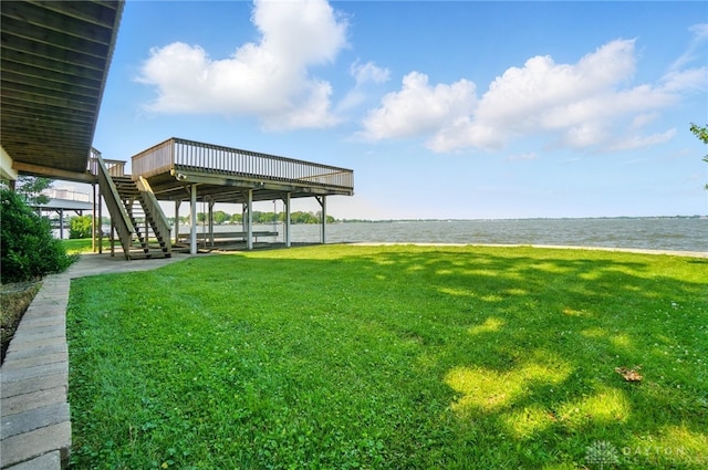 9113 Maple St, Huntsville, OH 43324 - view of green lawn featuring stairway and a deck with water view