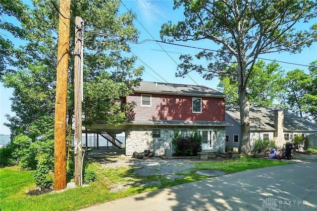 9113 Maple St, Huntsville, OH 43324 - view of front facade featuring stone siding and stairway