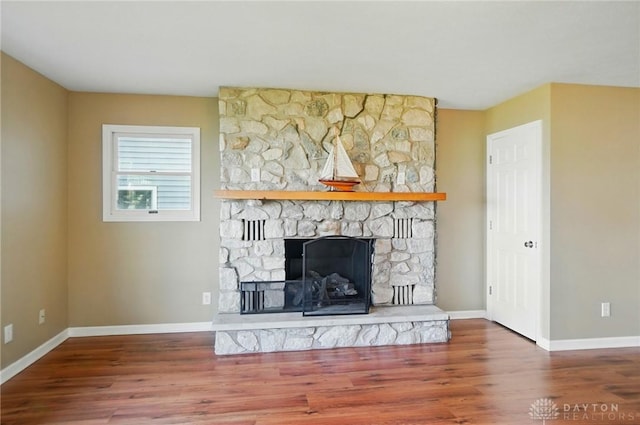9113 Maple St, Huntsville, OH 43324 - unfurnished living room with wood finished floors and a fireplace