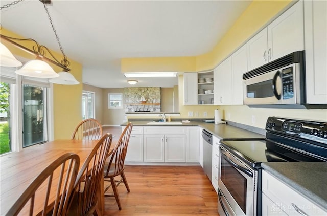 9113 Maple St, Huntsville, OH 43324 - kitchen with stainless steel appliances, white cabinetry, light wood-style floors, and open shelves