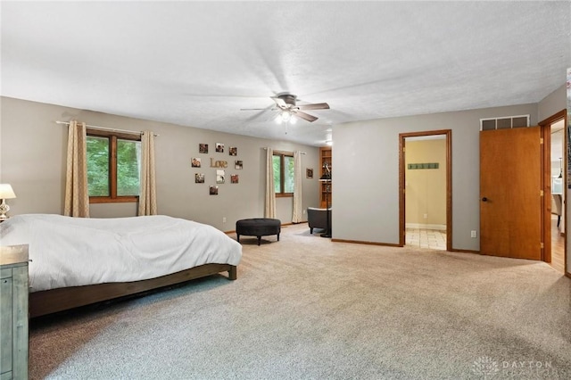 923 Lewis Creek Ct, Xenia, OH 45385 - bedroom with carpet, a ceiling fan, and connected bathroom