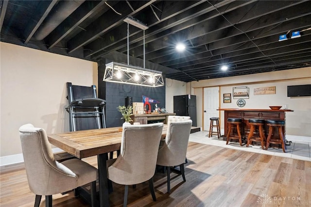 923 Lewis Creek Ct, Xenia, OH 45385 - dining area featuring a dry bar and light wood-style flooring