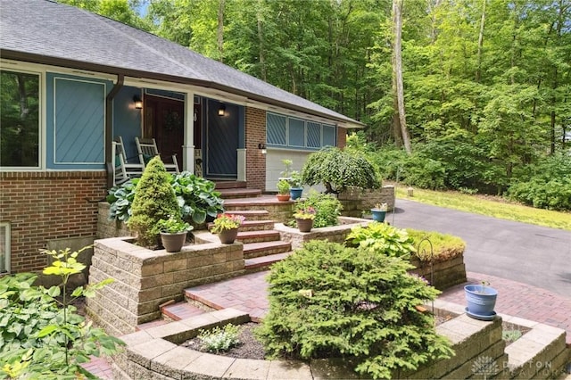 923 Lewis Creek Ct, Xenia, OH 45385 - doorway to property with brick siding, a shingled roof, and a wooded view