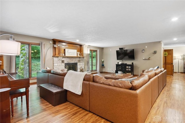 923 Lewis Creek Ct, Xenia, OH 45385 - living area featuring light wood-type flooring, a stone fireplace, and recessed lighting