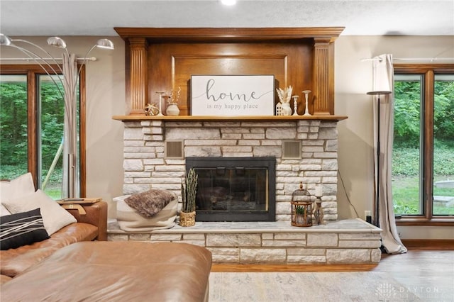 923 Lewis Creek Ct, Xenia, OH 45385 - living room with healthy amount of natural light, wood finished floors, and a fireplace