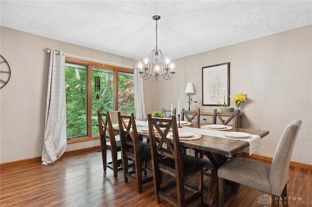 923 Lewis Creek Ct, Xenia, OH 45385 - dining room featuring a chandelier, wood finished floors, and a textured ceiling