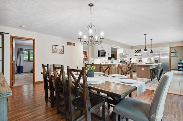 923 Lewis Creek Ct, Xenia, OH 45385 - dining room with light wood finished floors and a chandelier