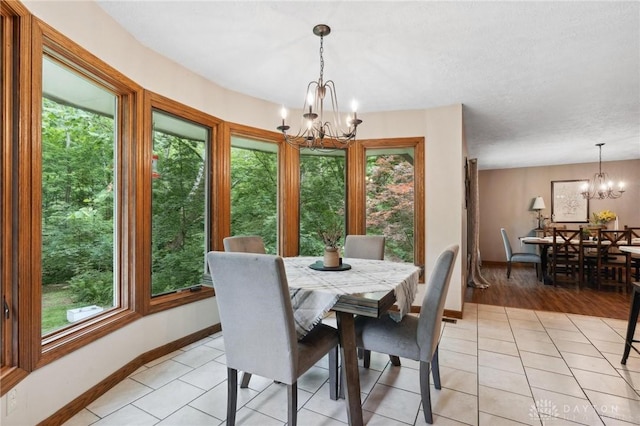 923 Lewis Creek Ct, Xenia, OH 45385 - dining space with a chandelier, healthy amount of natural light, and light tile patterned floors