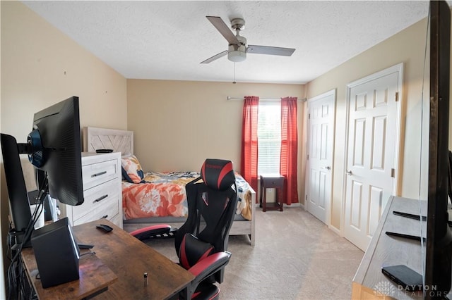 12052 Doe Run Ct, Springfield Twp, OH 45240 - bedroom with an office area, light colored carpet, two closets, a textured ceiling, and ceiling fan