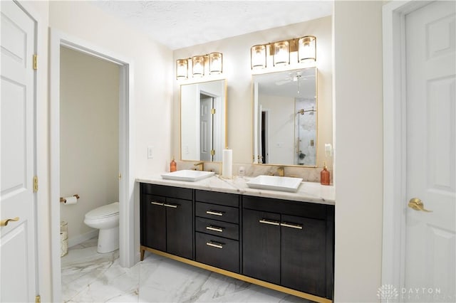 12052 Doe Run Ct, Springfield Twp, OH 45240 - bathroom featuring marble look tiles, double vanity, a shower stall, and ceiling fan