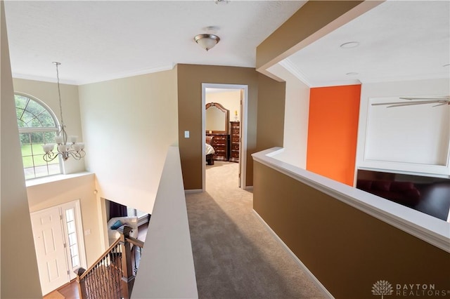 12052 Doe Run Ct, Springfield Twp, OH 45240 - hallway with a chandelier, an upstairs landing, ornamental molding, and carpet