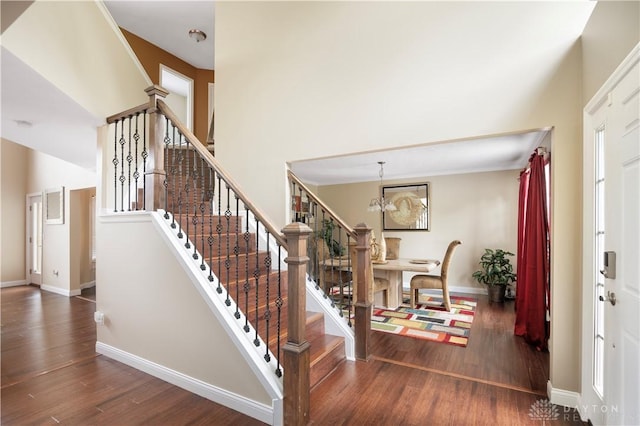 12052 Doe Run Ct, Springfield Twp, OH 45240 - foyer with wood finished floors, stairs, a chandelier, and a towering ceiling