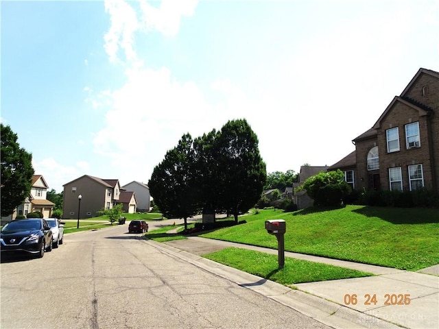 12052 Doe Run Ct, Springfield Twp, OH 45240 - view of asphalt road with a residential view, curbs, and sidewalks