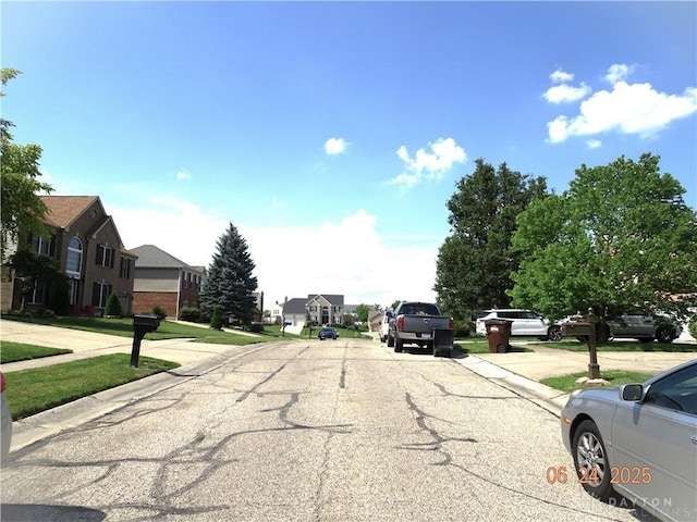 12052 Doe Run Ct, Springfield Twp, OH 45240 - view of asphalt road featuring a residential view, curbs, and sidewalks