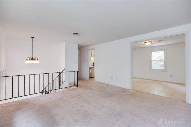 113 Marrett Farm Rd, Englewood, OH 45322 - spare room featuring a chandelier and light carpet