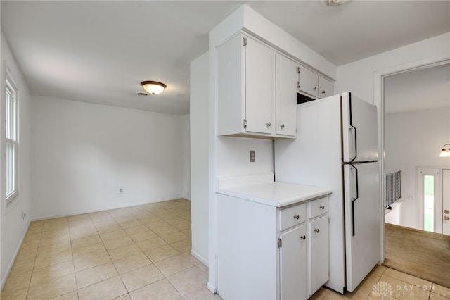 113 Marrett Farm Rd, Englewood, OH 45322 - kitchen featuring freestanding refrigerator, light countertops, light tile patterned flooring, and white cabinets