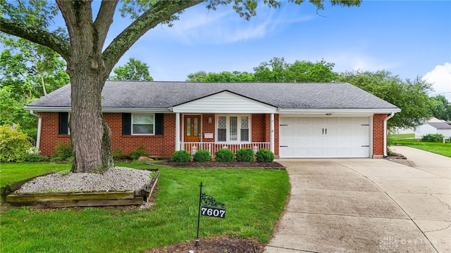7607 Plamor Cir, Centerville, OH 45459 - ranch-style home featuring driveway, brick siding, covered porch, a garage, and a front lawn