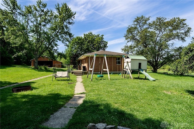4675 Dearth Rd, Franklin Twp, OH 45005 - view of green lawn with a playground and an outbuilding