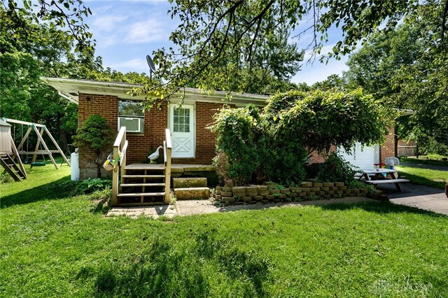 4675 Dearth Rd, Franklin Twp, OH 45005 - view of front of property with brick siding, a playground, and a front yard