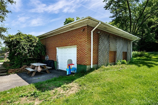 4675 Dearth Rd, Franklin Twp, OH 45005 - view of property exterior with a yard, brick siding, and a garage