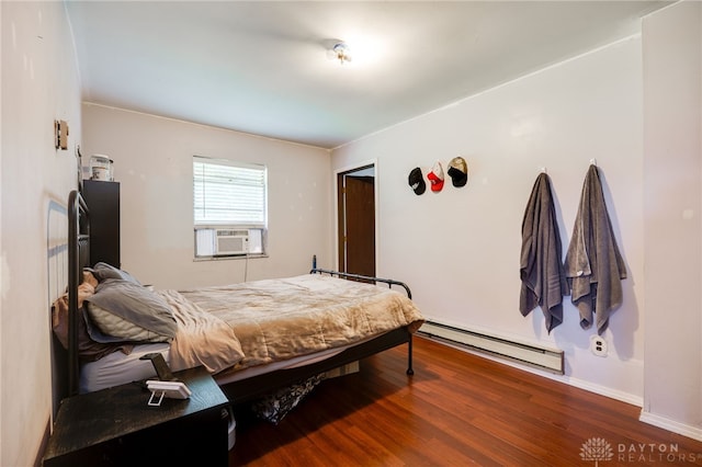 4675 Dearth Rd, Franklin Twp, OH 45005 - bedroom featuring a baseboard heating unit, cooling unit, and wood finished floors