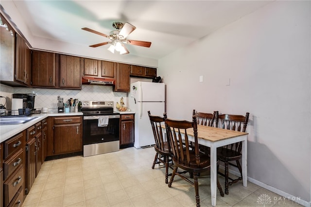 4675 Dearth Rd, Franklin Twp, OH 45005 - kitchen with electric range, freestanding refrigerator, light countertops, a ceiling fan, and decorative backsplash