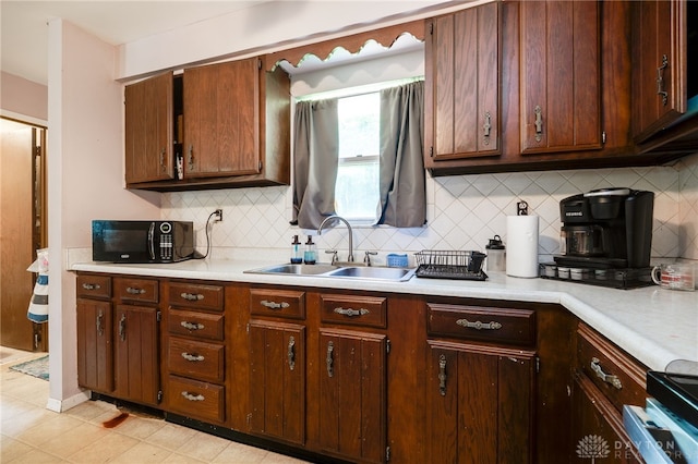 4675 Dearth Rd, Franklin Twp, OH 45005 - kitchen with black microwave, light countertops, tasteful backsplash, and range