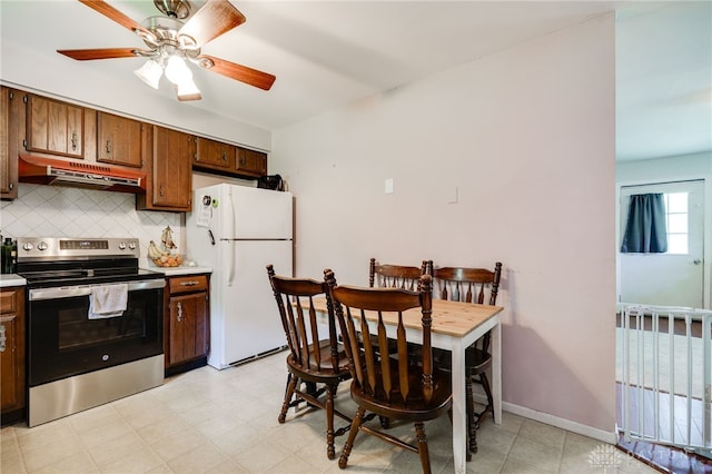 4675 Dearth Rd, Franklin Twp, OH 45005 - kitchen featuring electric stove, freestanding refrigerator, under cabinet range hood, tasteful backsplash, and light countertops