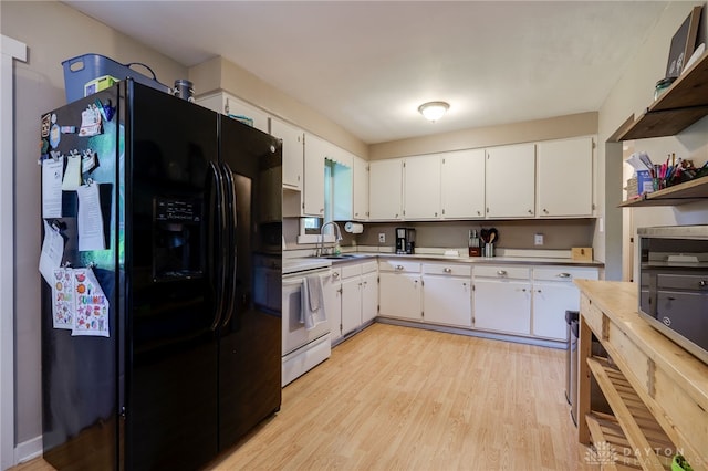 4675 Dearth Rd, Franklin Twp, OH 45005 - kitchen featuring black fridge with ice dispenser, white electric range oven, light wood-style flooring, and white cabinetry