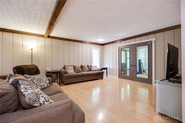 4675 Dearth Rd, Franklin Twp, OH 45005 - living area featuring french doors, light wood finished floors, a decorative wall, and beamed ceiling