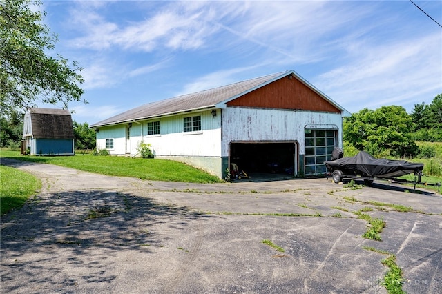 4675 Dearth Rd, Franklin Twp, OH 45005 - view of property exterior featuring an outbuilding, asphalt driveway, and a garage