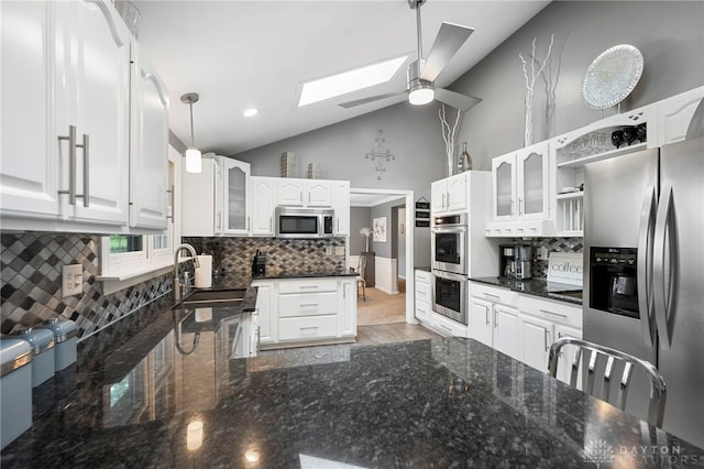 440 David Ln, Mason, OH 45040 - kitchen featuring stainless steel appliances, a skylight, a ceiling fan, vaulted ceiling, and decorative backsplash