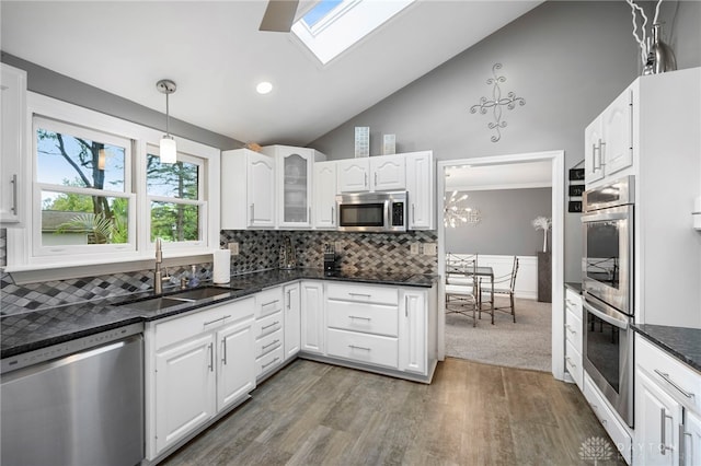 440 David Ln, Mason, OH 45040 - kitchen with appliances with stainless steel finishes, light wood-style floors, glass insert cabinets, a skylight, and white cabinets