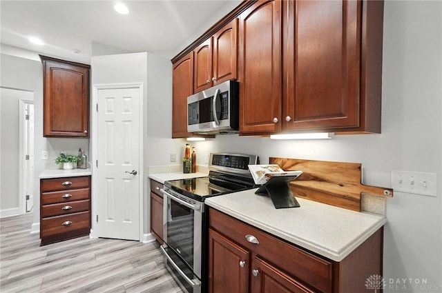 10101 Sawtry Ln, Washington Twp, OH 45458 - kitchen featuring appliances with stainless steel finishes, light countertops, light wood-type flooring, and recessed lighting
