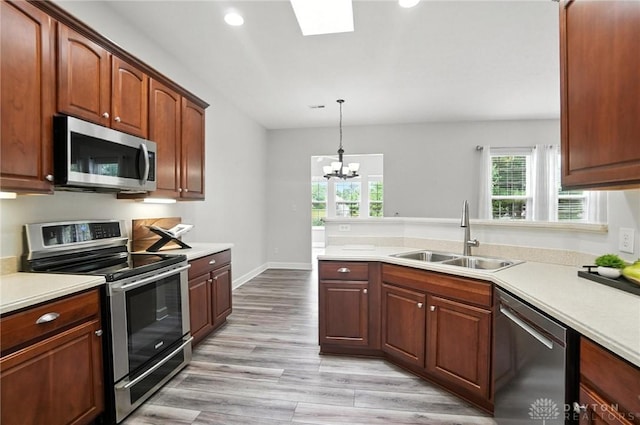 10101 Sawtry Ln, Washington Twp, OH 45458 - kitchen featuring stainless steel appliances, light countertops, healthy amount of natural light, a chandelier, and recessed lighting